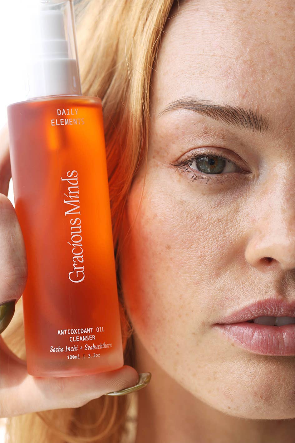 Gracious Minds Antioxidan oil cleaners next to a female face